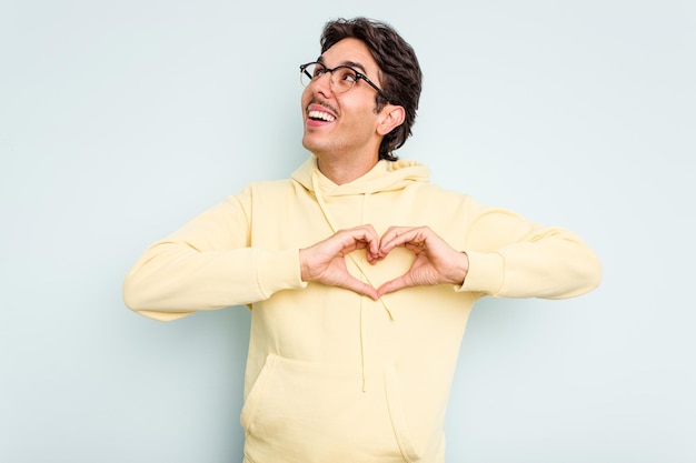 Smiling and showing a heart shape with hands