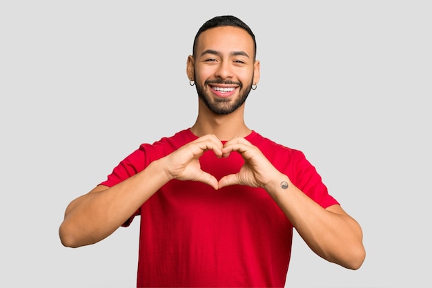 Smiling and showing a heart shape with hands