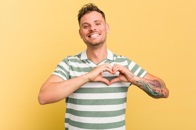 Smiling and showing a heart shape with hands