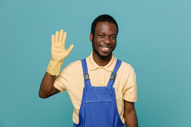 smiling showing hello gesture young africanamerican cleaner male in uniform with gloves isolated on blue background