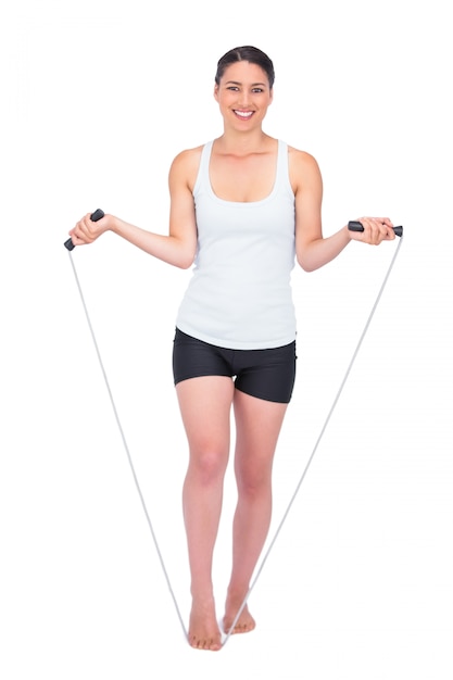 Smiling slender model jumping rope