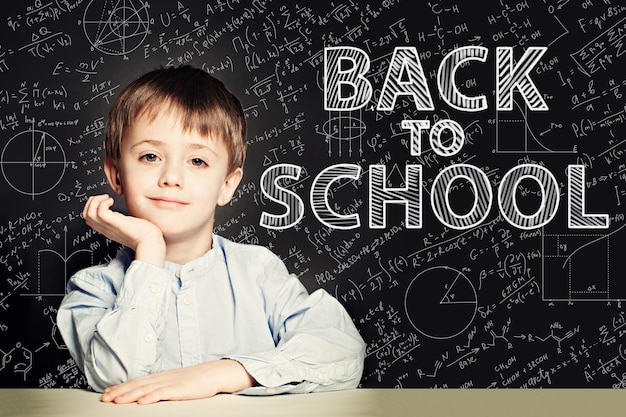 Smiling Student child thinking on chalkboard Back to school con