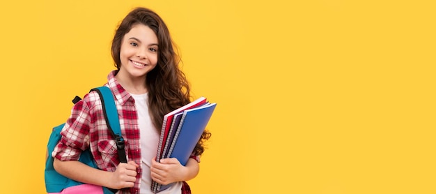 Smiling student education and knowledge high school schoolgirl with notebook and backpack Portrait of schoolgirl student studio banner header School child face copyspace