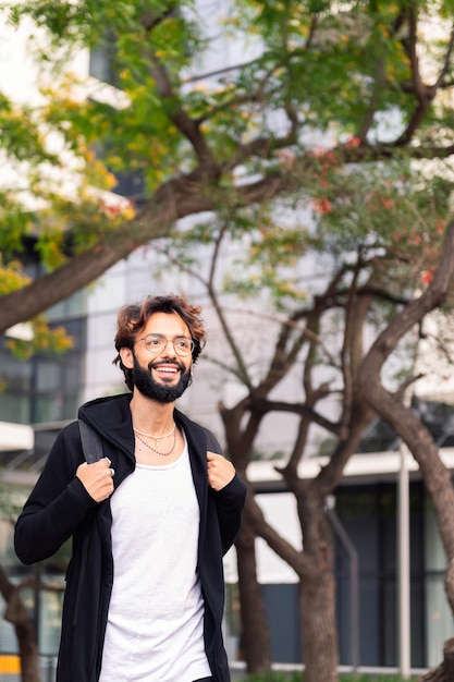 Smiling student walking happy by the campus