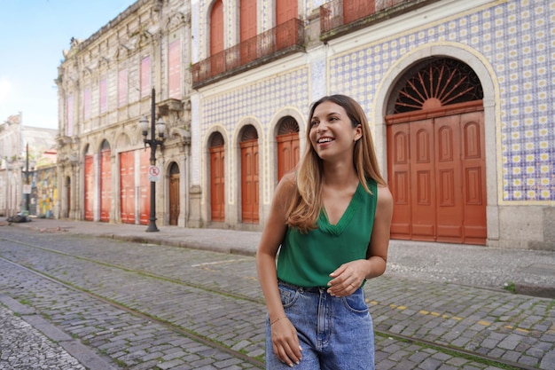 Smiling stylish girl visiting the historic center of Santos Sao Paulo Brazil