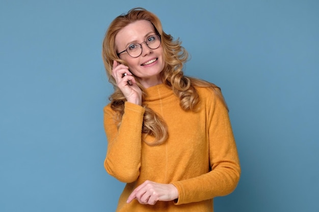 Smiling successful businesswoman with cell phone isolated on white background