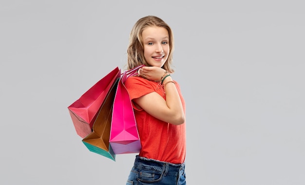 smiling teenage girl with shopping bags