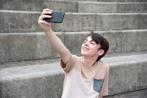 Smiling teenager boy taking selfie