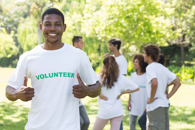 Smiling volunteer showing thumbs up