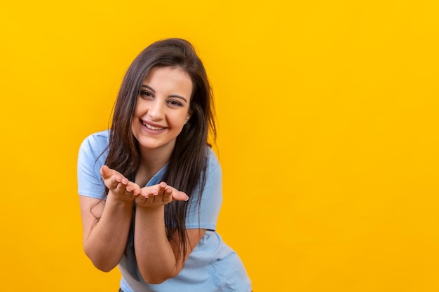 Smiling woman blowing a kiss with two hands