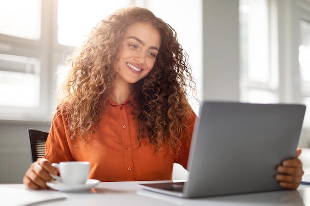 Smiling woman enjoying video call on tablet