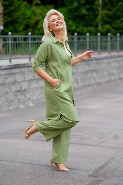 Smiling woman in green suit outdoors