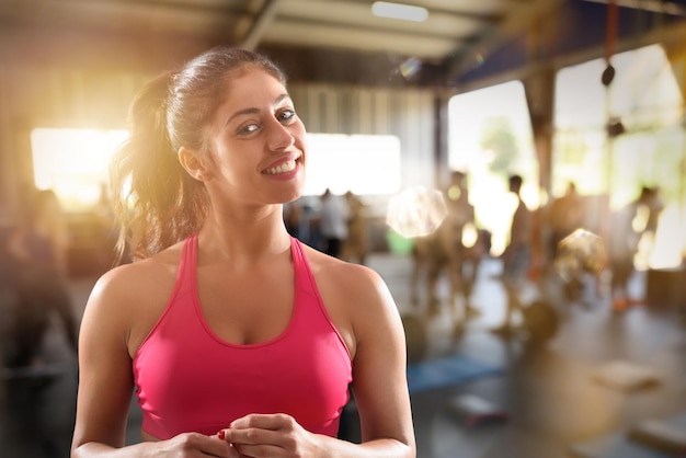 Smiling woman at the gym ready to start fitness lesson