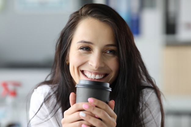 Smiling woman hold black paper moog with