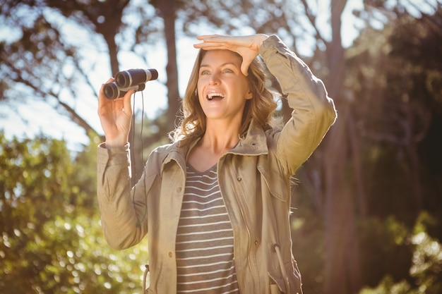 Smiling woman holding binoculars