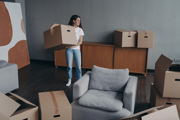 Smiling woman holding cardboard box moving in new home Bank loan and mortgage tenancy concept