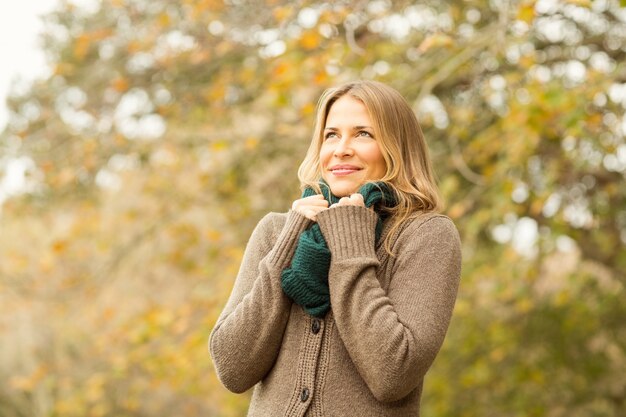 Smiling woman holding her scarf