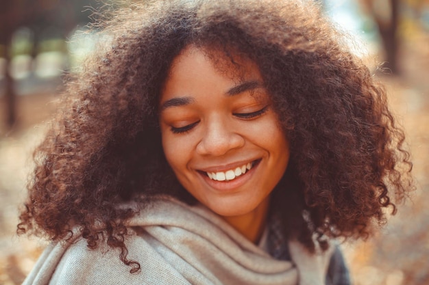 Smiling woman looking down outdoors