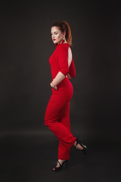 Smiling woman portrait. girl wearing red overalls