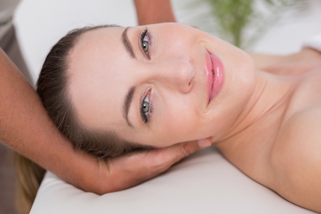 Smiling woman receiving neck massage 