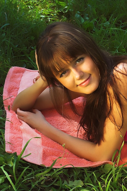 Smiling woman relaxes on the grass