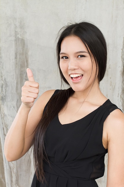 Smiling woman showing thumb up positive attitude