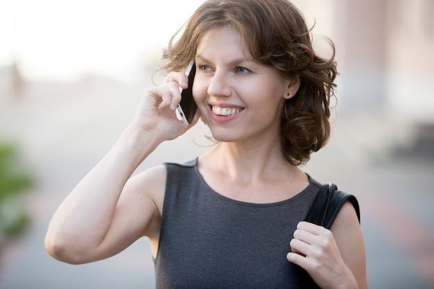 Smiling woman talking on a mobile