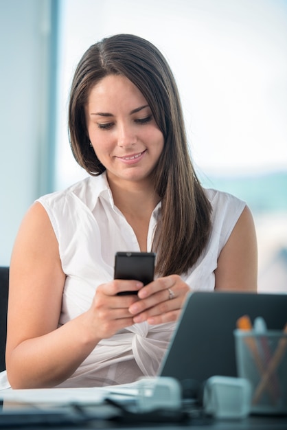 Smiling woman texting