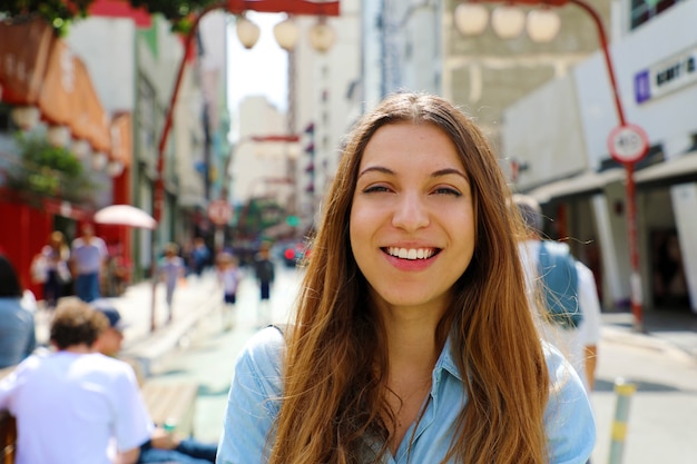 Smiling woman walking in Sao Paulo japanese neighborhood