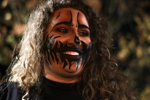 Smiling woman with halloween night makeup Portrait of a woman with halloween night makeup outdoors