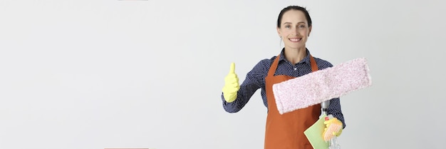 Smiling woman with mop holding thumb up recommendations for cleaning cleaning companies concept