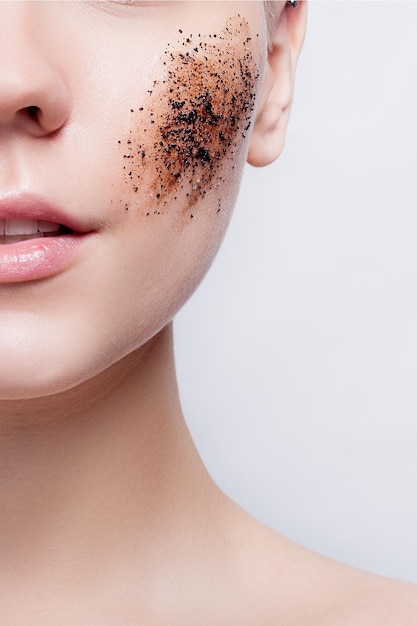 Smiling woman with short hair bald cleans the skin coffee skrub studio shot closeup portrait