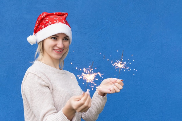 A smiling woman with sparklers in her hands Holidays and events Christmas