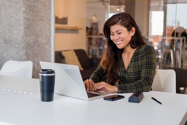 Smiling woman working on laptop