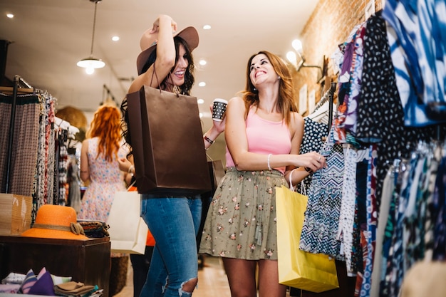 Smiling women choosing clothes