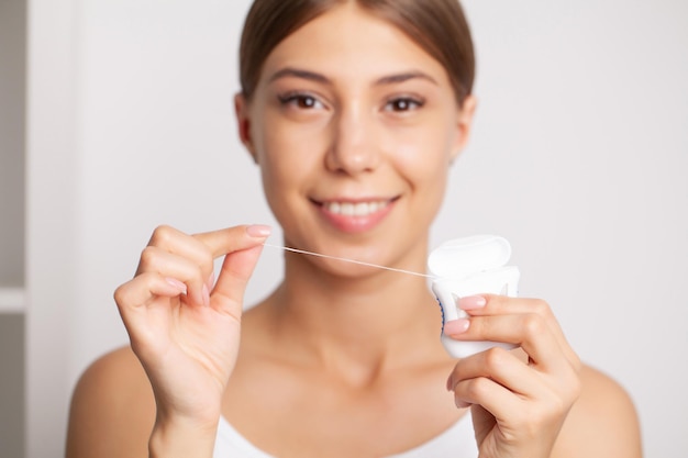 Smiling women use dental floss white healthy teeth