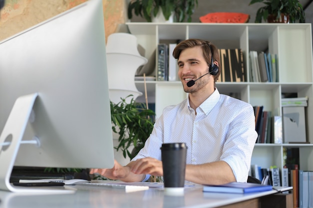 Smiling young business man having video call in office.