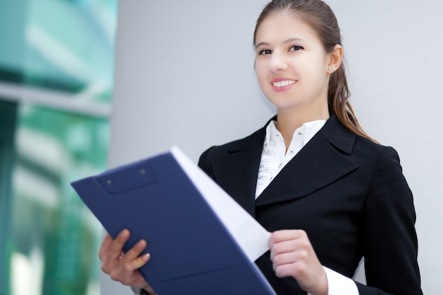 Smiling young business woman outdoor