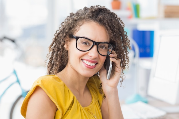 Smiling young businesswoman on the phone