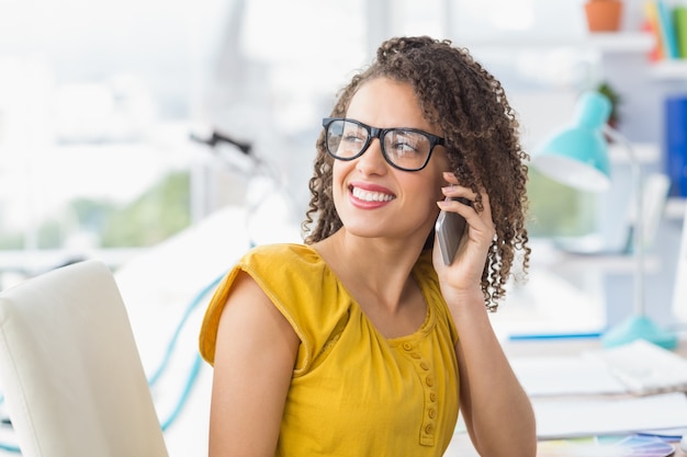 Smiling young businesswoman on the phone