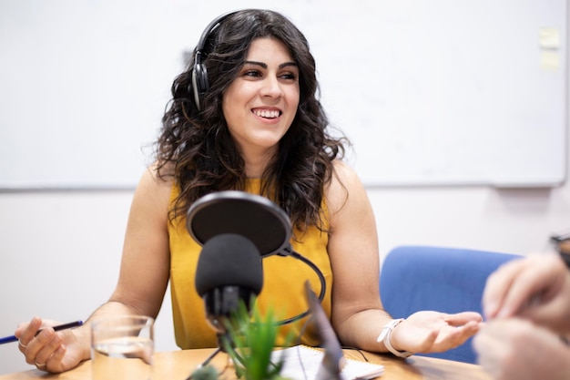 Smiling young caucasian woman during live broadcast