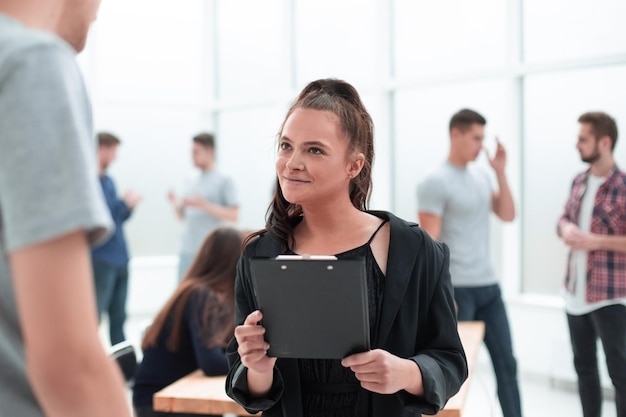 Smiling young colleagues reading a business document