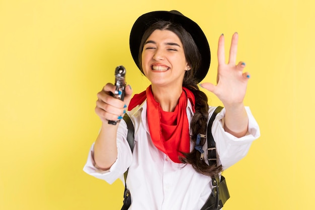 Smiling young cowgirl point gun to the camera High quality photo