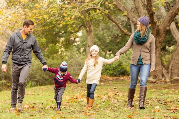 Smiling young family holding hands