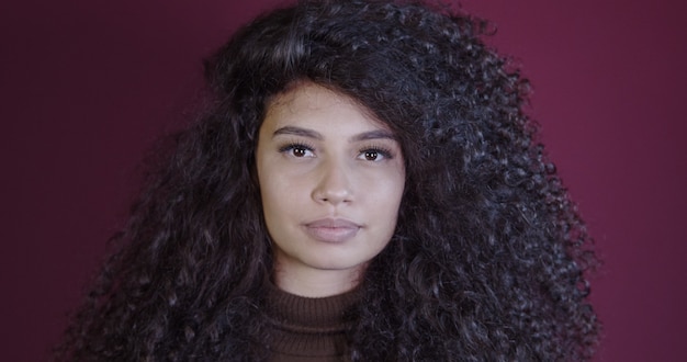 Smiling young latin afro woman. Joy, positive and love. Beautiful african-style hair.