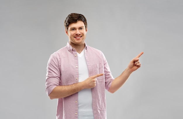 smiling young man showing something