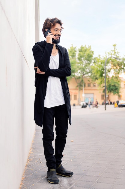 Smiling young man talking on mobile phone