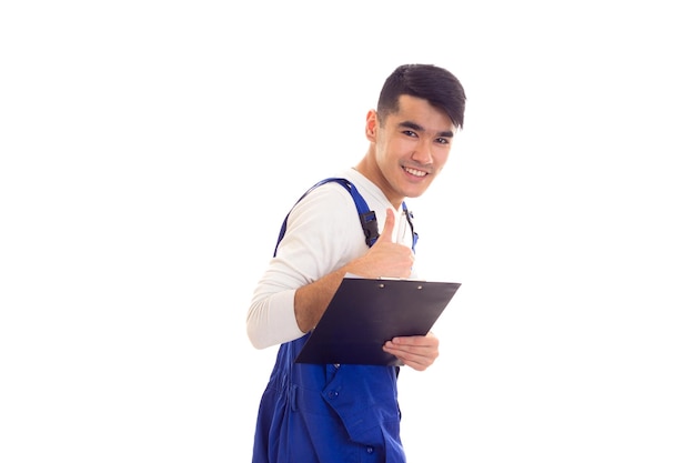 Smiling young man with dark hair wearing showing his black folder with white papers