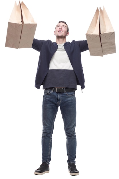 Smiling young man with shopping bags isolated on a white