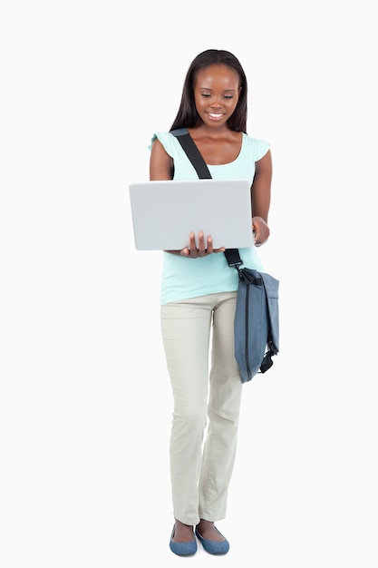 Smiling young student with her laptop